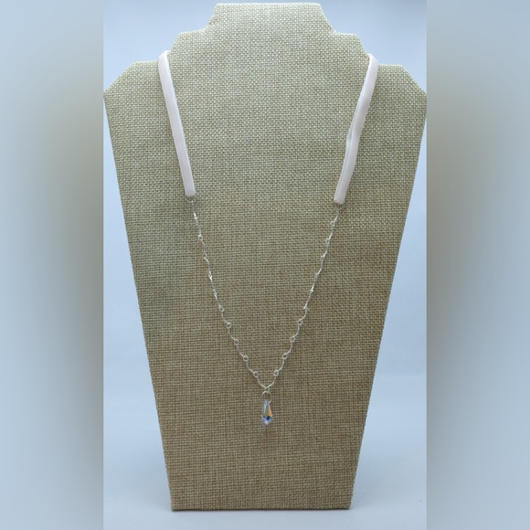 A small crystal tear pendant on a pink velvet and silver tone chain. - Picture 2 of 3